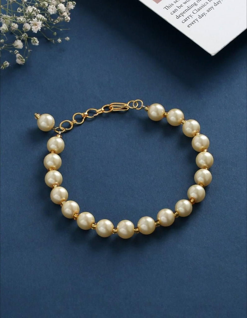 PD Enterprise Gold Plated Pearl Bracelet featuring a combination of gold-plated links and lustrous white pearls. The bracelet has an elegant design with a secure lobster clasp, offering a sophisticated and timeless accessory perfect for both casual and formal wear.