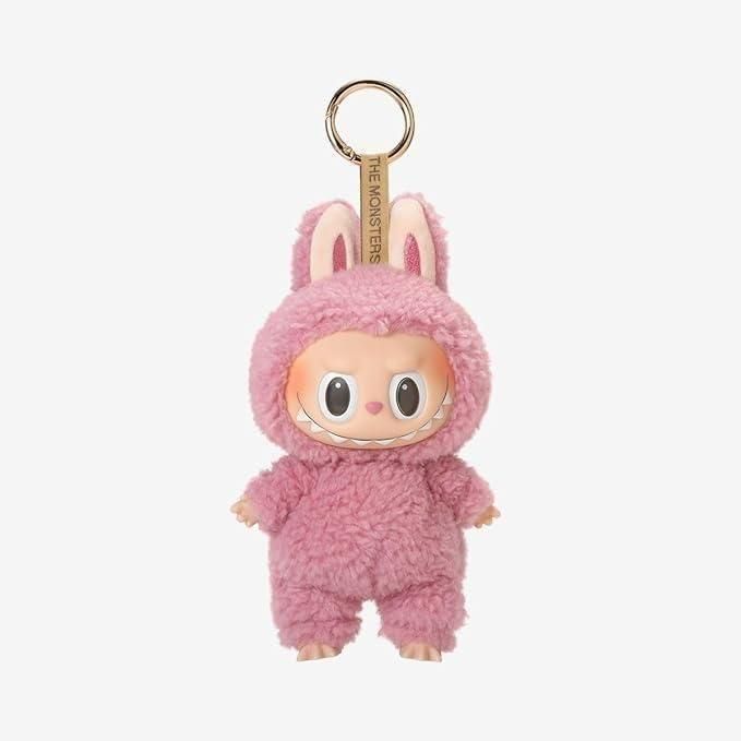 A cute keychain with a doll wearing a fluffy pink bunny costume.