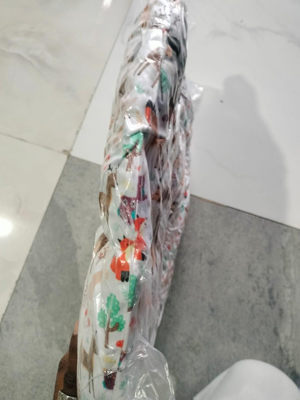 A packaged soft item with a colorful forest animal print, viewed from the side.