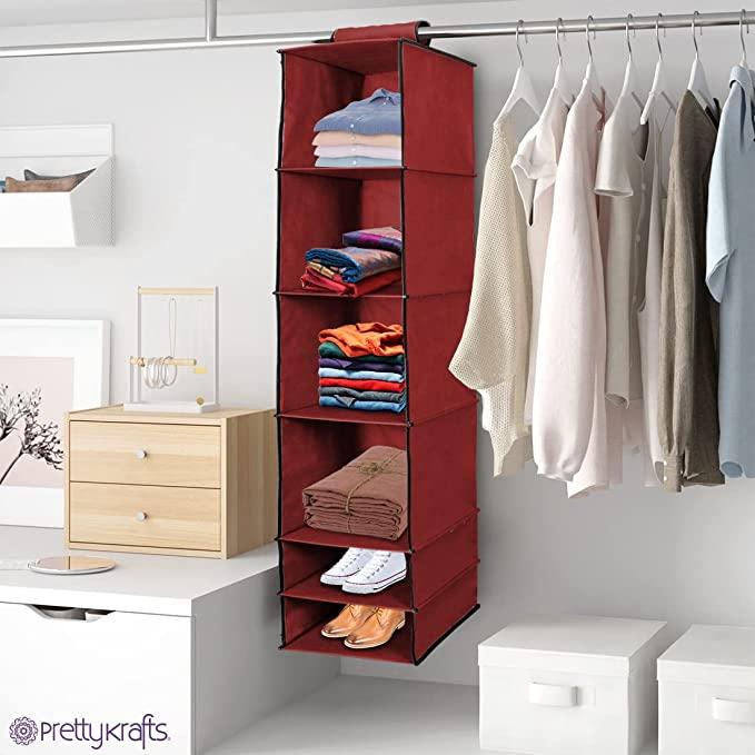 Angular view of A maroon Hanging Wardrobe Organizer with 6 foldable shelves, made from durable fabric