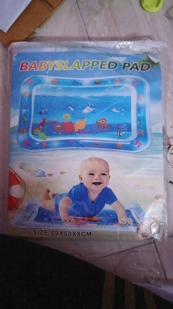 Packaging for a baby water play mat labeled 'BABY SLAPPED PAD' with an image of a smiling baby.