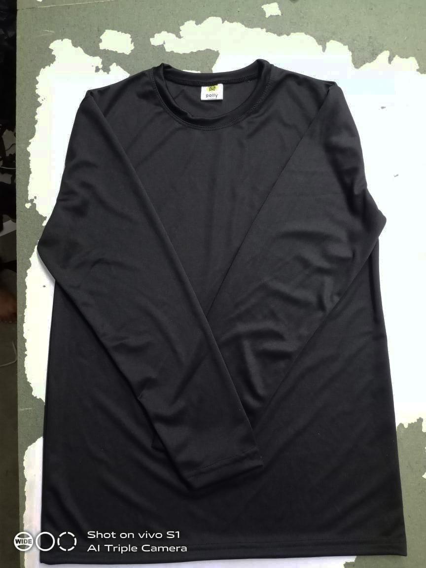 A plain black long-sleeve shirt laid flat on a surface.