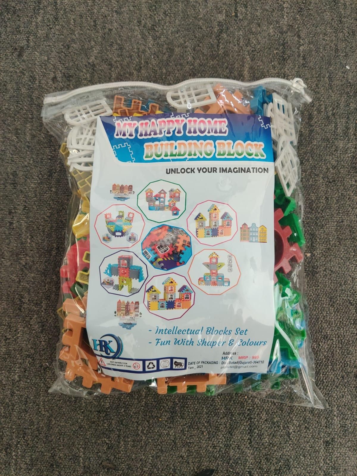 A clear plastic bag of colorful building blocks labeled 'My Happy Home Building Block' with illustrations of various block structures on the packaging.