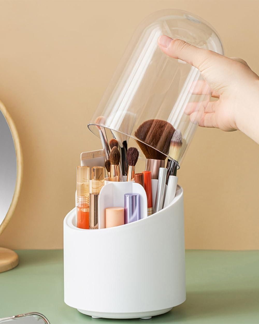 A white organizer holding various makeup brushes and cosmetics, with a person lifting a clear plastic lid.