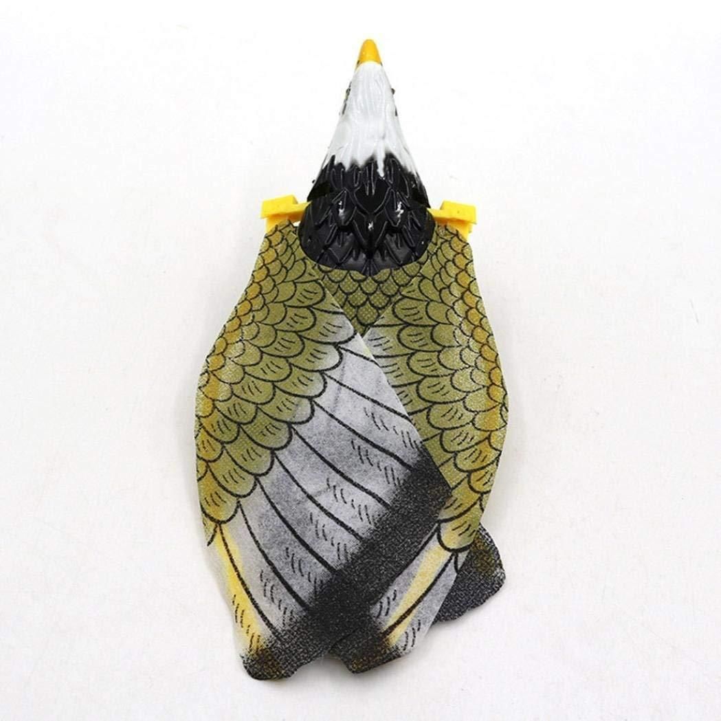 A plastic toy or decoy designed to look like a bird, with a white head, yellow beak, and greenish feather patterns on the body, viewed from above.