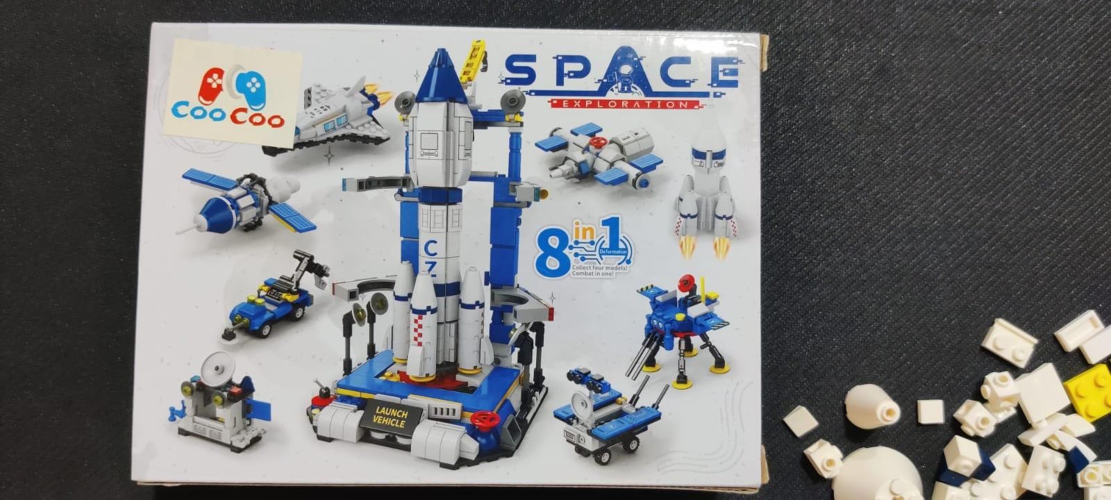 A box for a Coo Coo brand toy building set featuring a space exploration theme, with models of rockets, vehicles, and satellites on the cover.