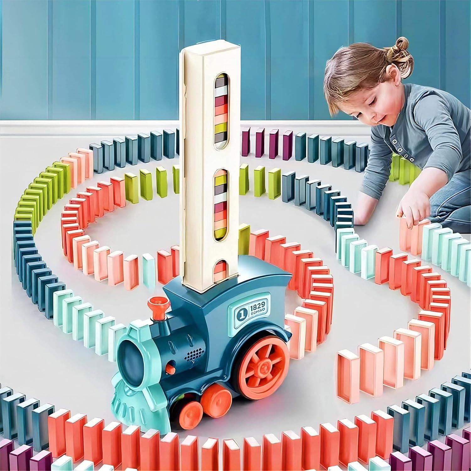 A child playing with a domino train toy that sets up colorful dominoes in a spiral pattern on the floor.
