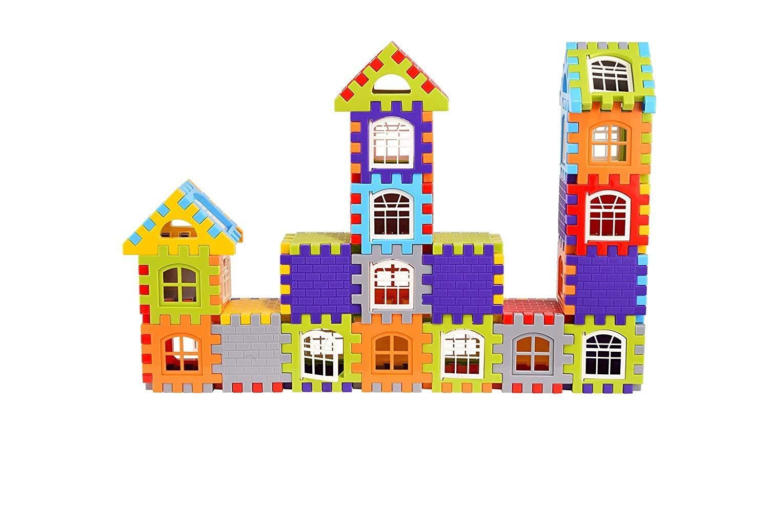 A colorful building structure made from interlocking plastic toy blocks, resembling houses with windows and rooftops.