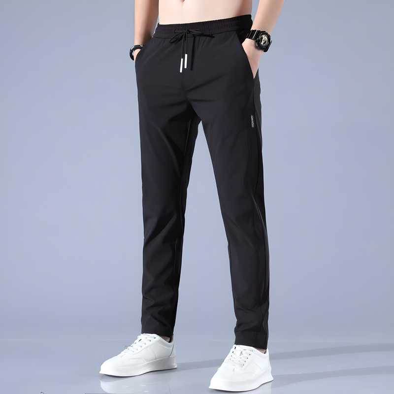 Men's black Lycra track pants with a solid design, regular fit, and 39-inch length, perfect for active and casual wear.