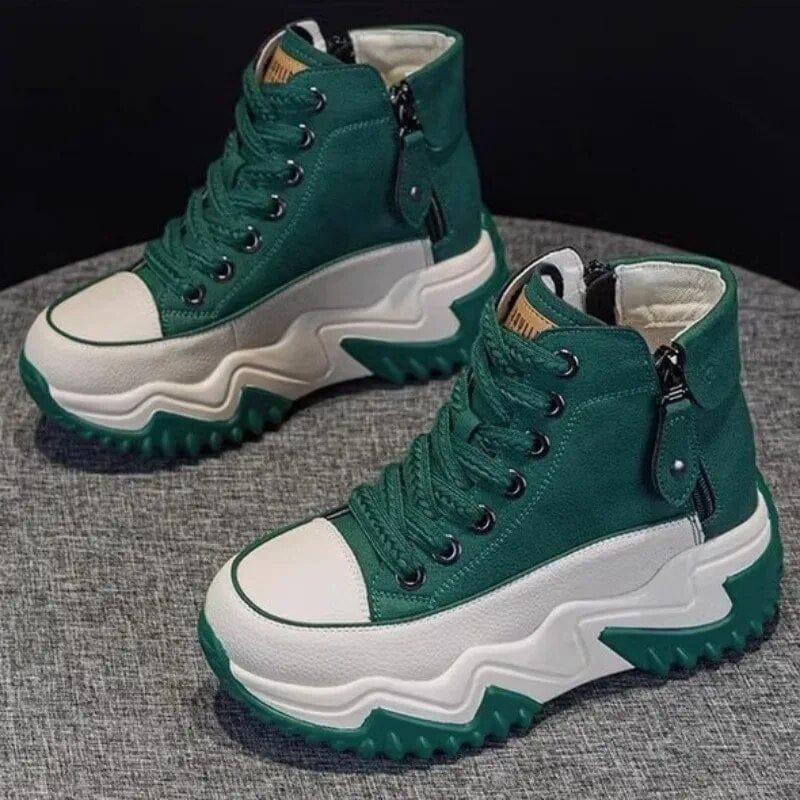 A pair of green and white high-top sneakers with thick, zigzag soles.