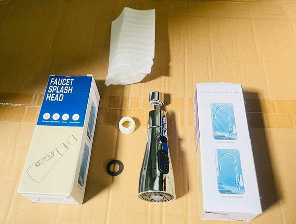 A faucet splash head kit displayed on a cardboard surface, including a faucet attachment, two washers, protective foam, and two product boxes.