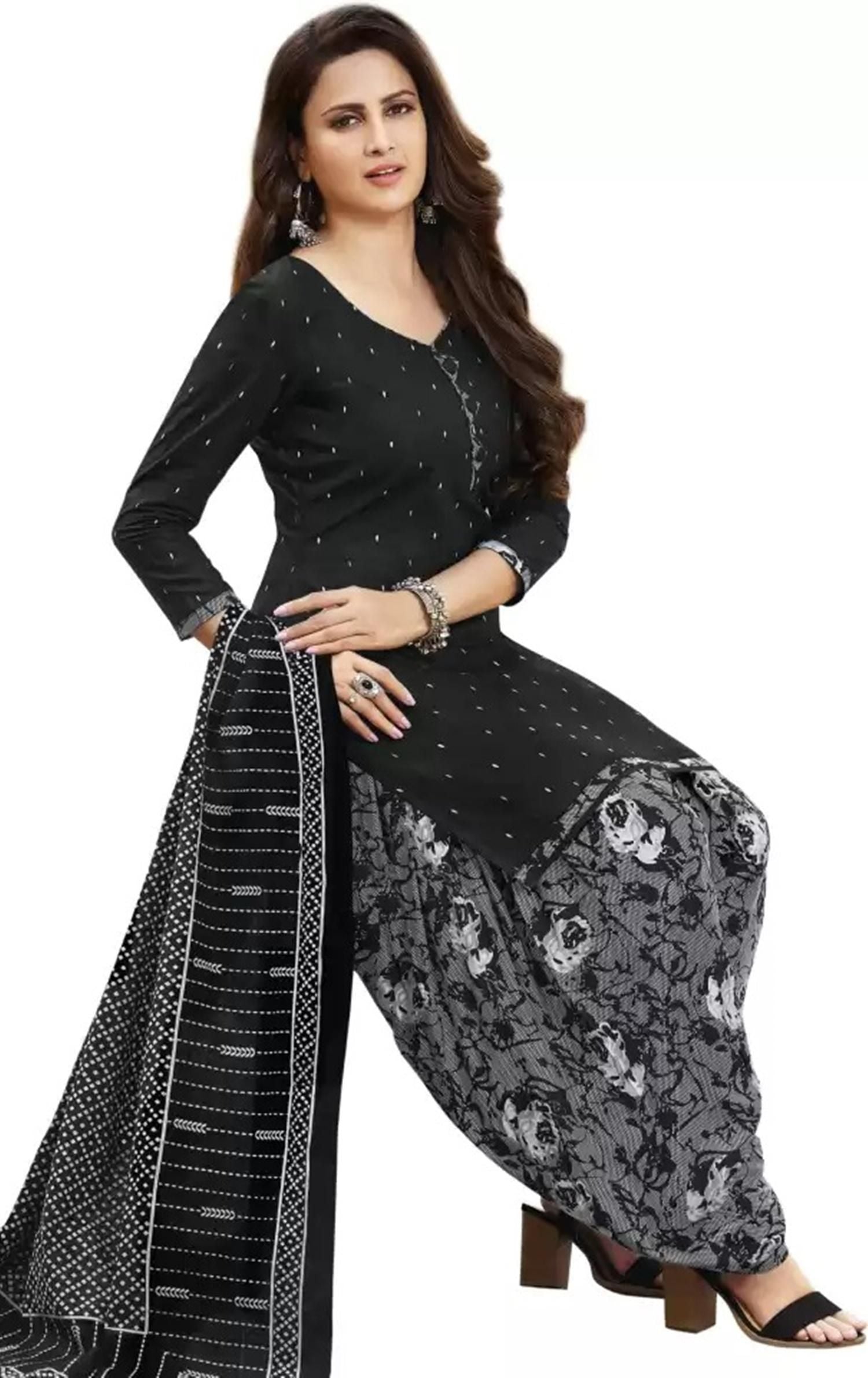 A woman wearing a black printed salwar kameez with a patterned dupatta and floral design pants.